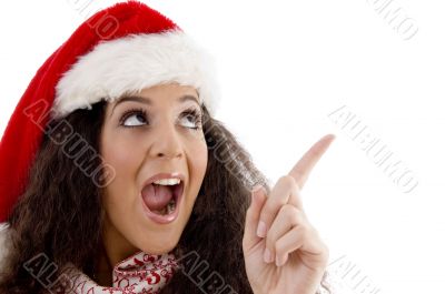 young woman with christmas hat indicating upward