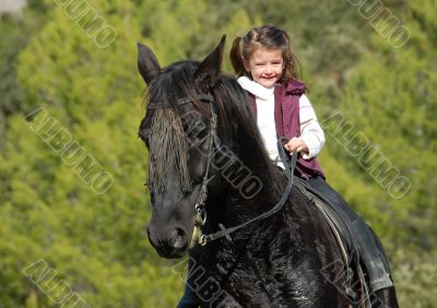little girl and her black horse