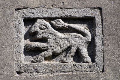 Ancient stone panel on a church in Tuscany