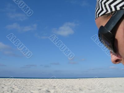 girl with shades on a beach