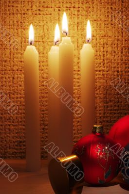 The burning candles, balls and ribbons it are Christmas