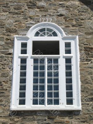 white window and stone wall