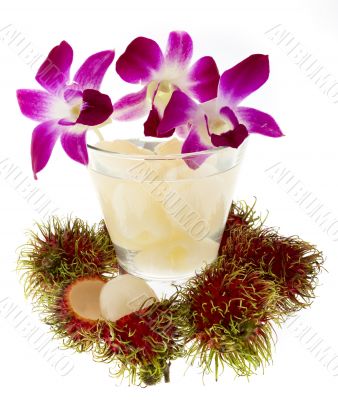 Rambutan with fruit juice and orchid
