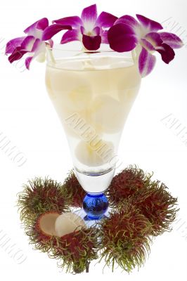 Rambutan with fruit juice and orchid