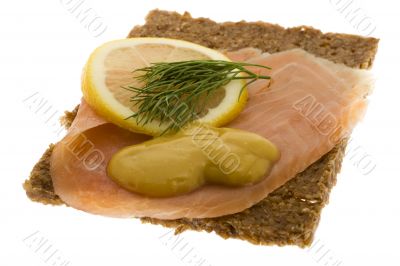 Salmon garnished on wholemeal bread