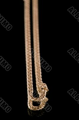 Golden chain on black closeup