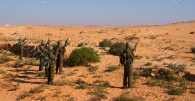 Israeli soldiers excersice in a desert