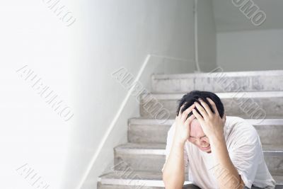 Frustrated man sitting alone