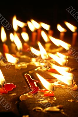 Burning candles on ground