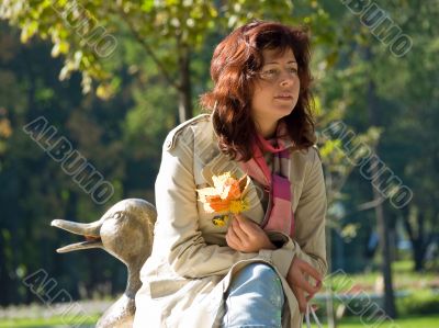 Woman with autumn leaves