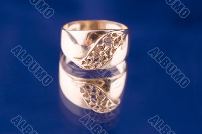 Golden ring close up on blue