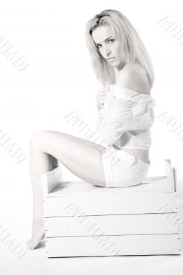 Woman sitting on a wooden case