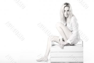 Woman sitting on a wooden case