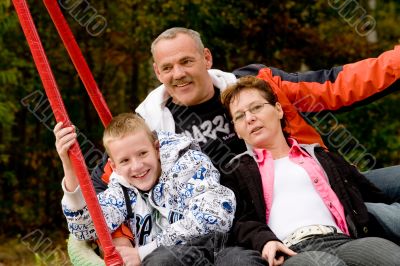 Happy family on the swing