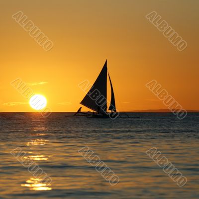 Drifting boat on a sunset