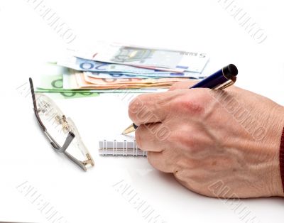 Hand, pen, notebook, glasses and money