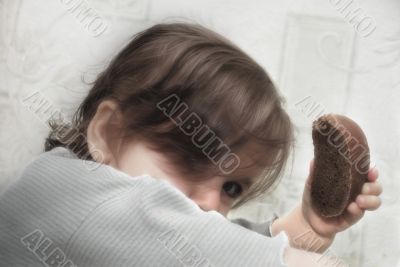 Lovely little girl with bread