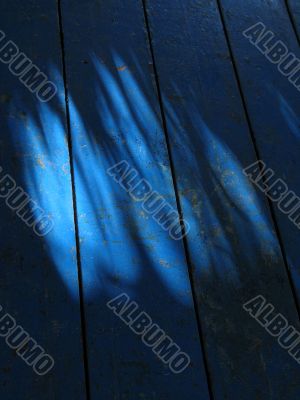light and shadow on a blue floor