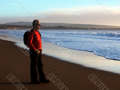 Man enjoying sunset by the ocean
