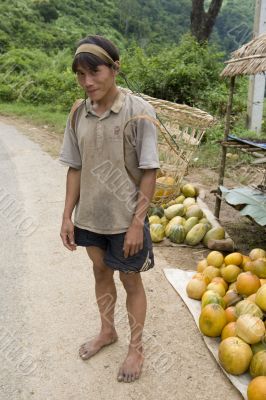 Hmong man in Laos with grape container