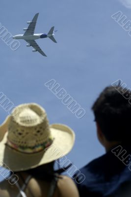 Airbus plane overhead with spectators