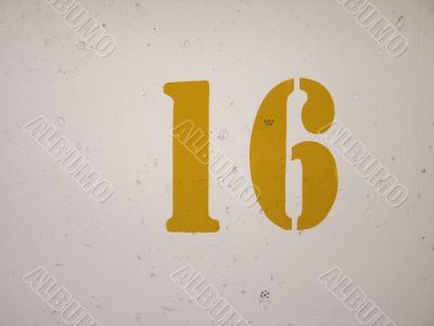 yellow number on a wall