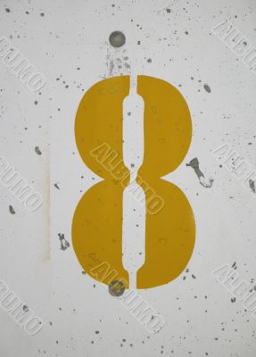 yellow number on a wall