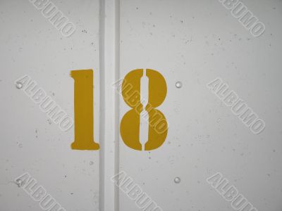 yellow number on a wall