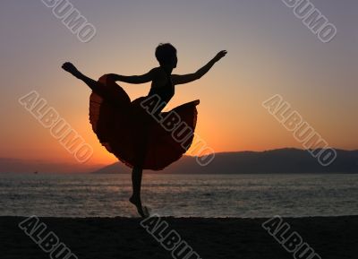 Dancing woman on the beach