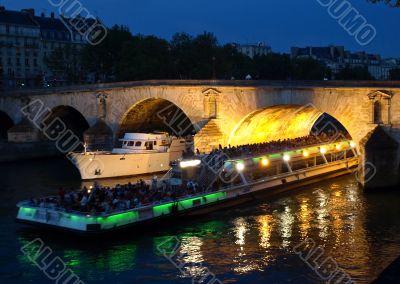Boats on the night Seine in Paris