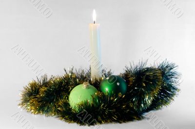 candle and green christmas balls