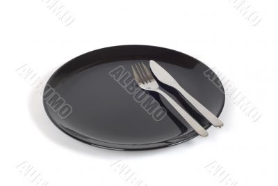 Black plate with knife and fork