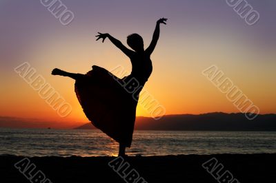 Dancing woman at sunset