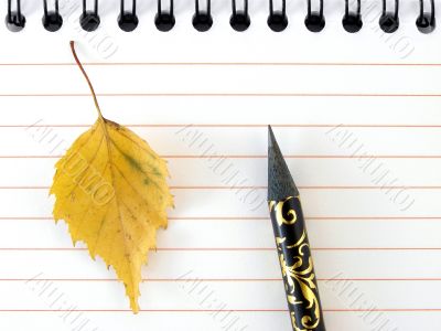 notepad with yellow leaf