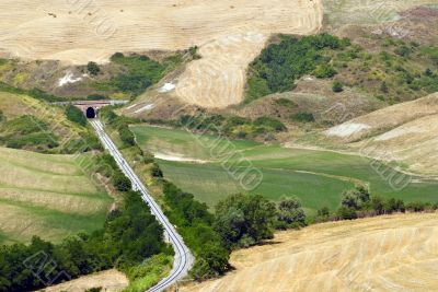 Crete senesi, characteristic landscape in Val d`Orcia - Railway