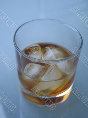 drink with ice on a glass table