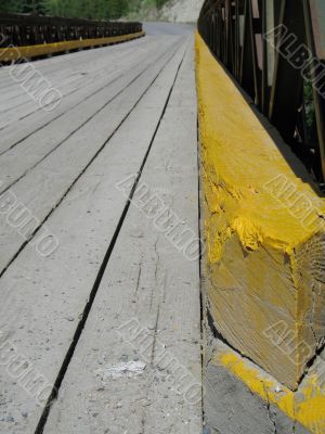 wooden bridge with yellow line