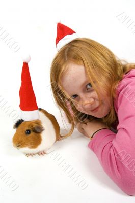 cute little red hair girl together with her guinea pig wearing a