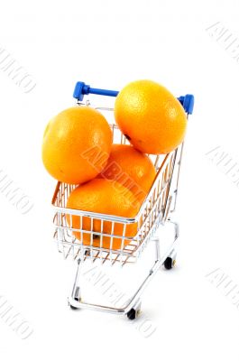 shopping cart filled with mandarines  isolated on white