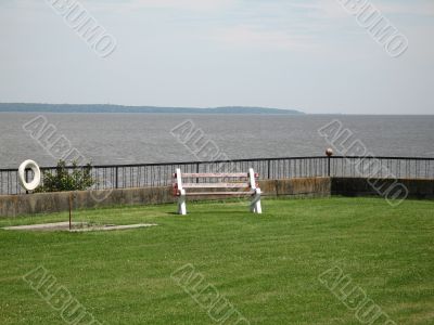bench on the grass by the ocean