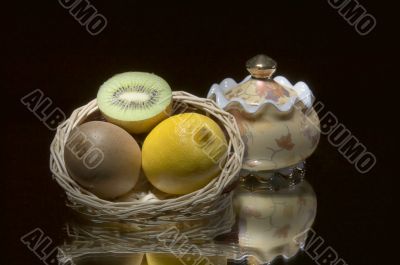 Lemon,kiwi,basket and sugar bowl.