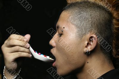 Asian punk man eat pills