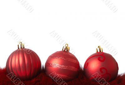 Red Christmas baubles on fur