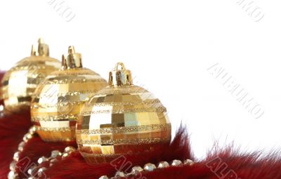 Gold Christmas baubles on fur