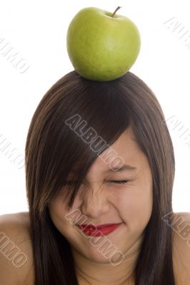 Teenager with apple at the head