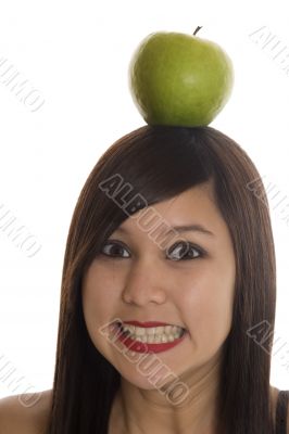 Teenager with apple at the head