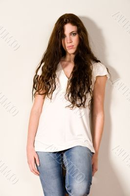Pretty young girl standing against a wall