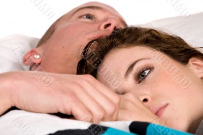 Young couple in bed thinking their thoughts