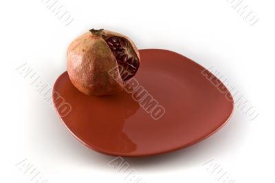 pomegranate on the red plate