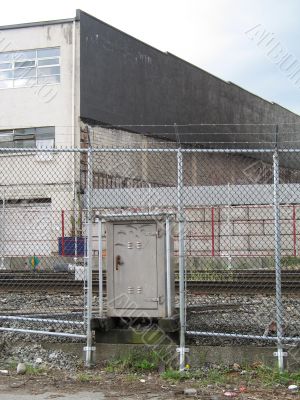industrial building behind a fence